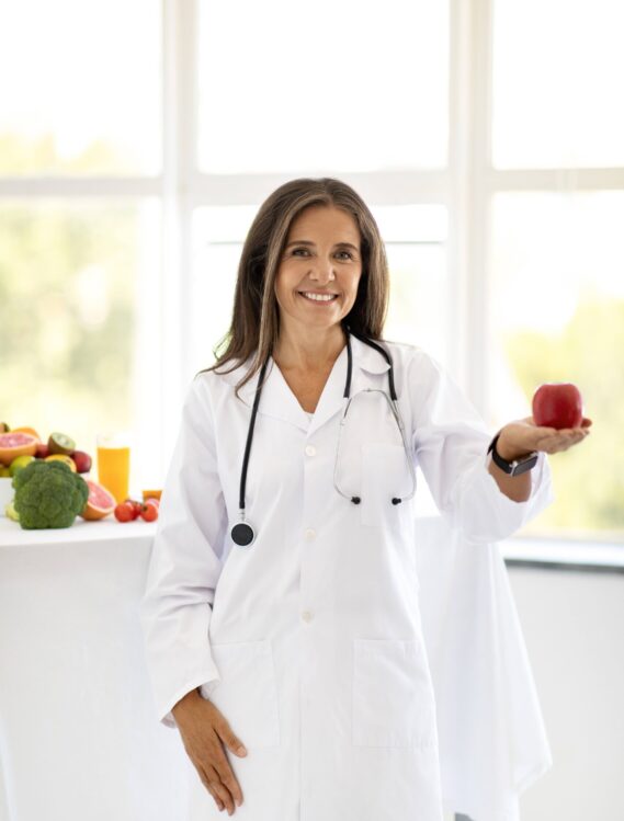 woman-doctor-in-white-coat-holding-red-apple-2026-01-08-23-10-11-utc